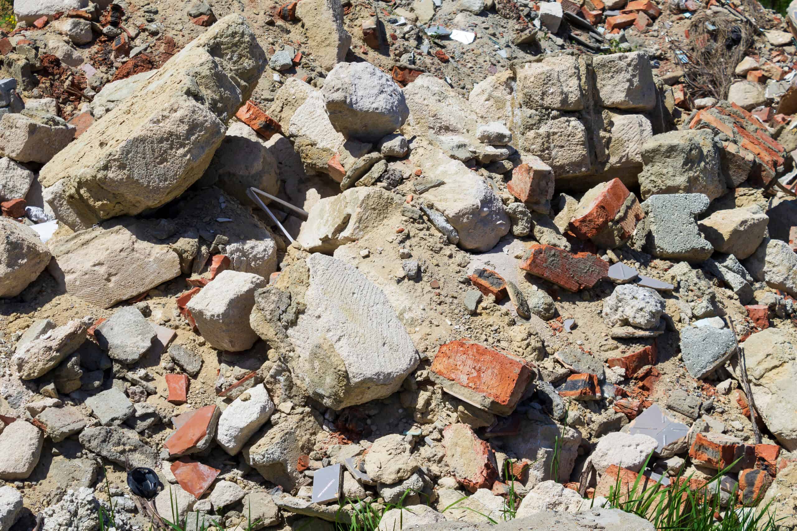 Pile of broken concrete, dirt, and bricks that cannot go in a roll-off dumpster
