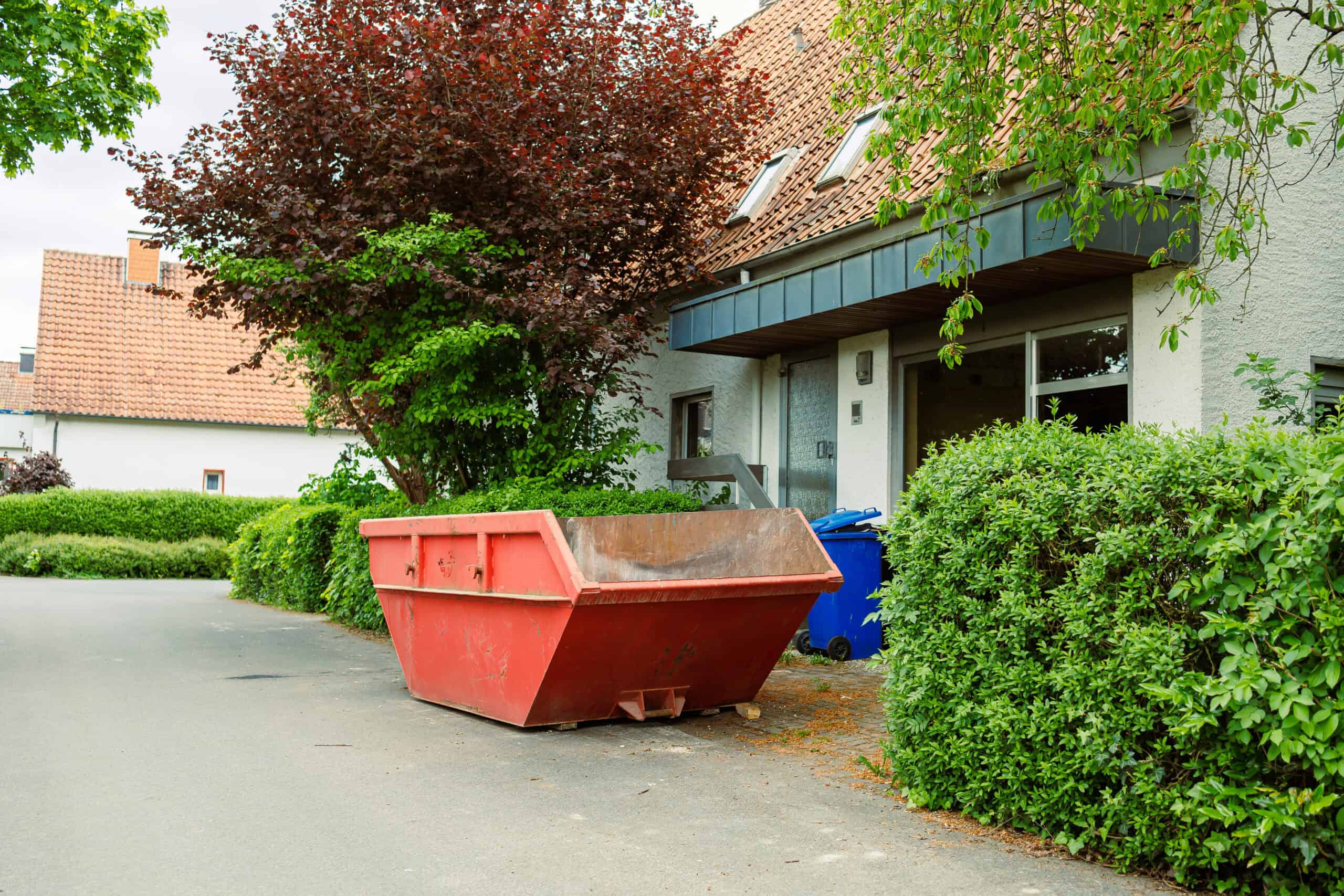 Roll-off dumpster placed on a residential driveway