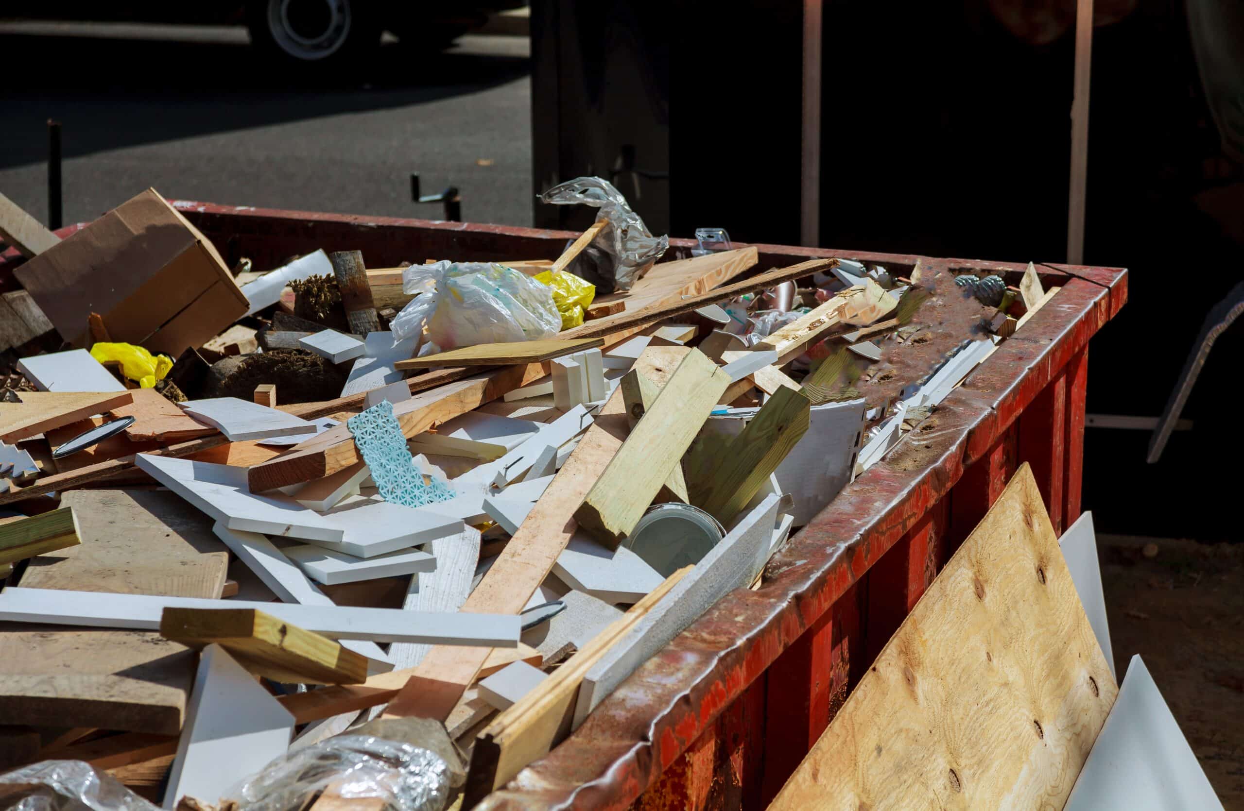 How to Estimate Dumpster Weight and Avoid Overage Fees 1 Roll-off dumpster loaded with heavy construction debris